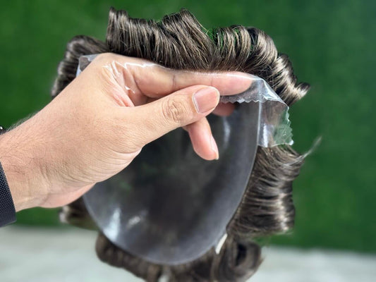 Prótese Capilar Masculina being held, showcasing high-quality human hair and realistic design for men.