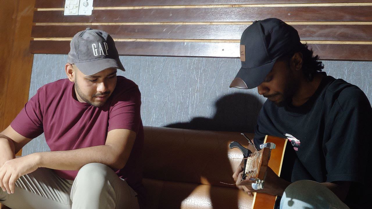 Musician playing guitar during an indoor creative session