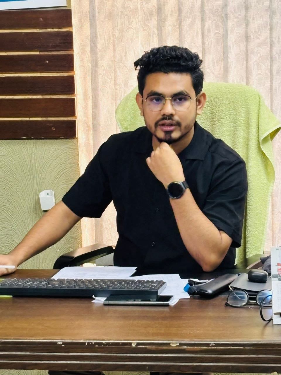 Meeting lead speaking from a desk during the monthly employee meeting