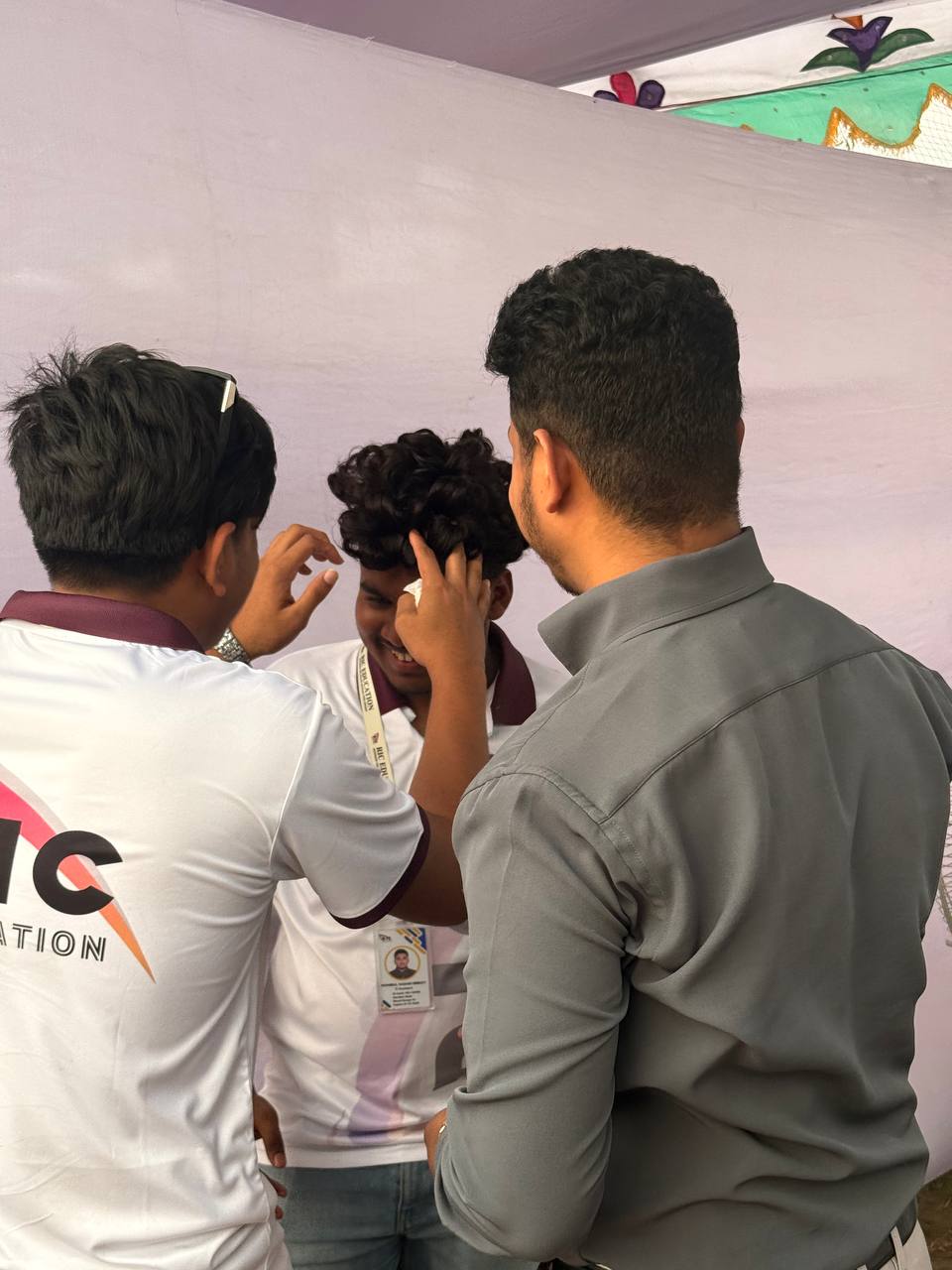 Wig Bangladesh team helping a student try a hair system at Uttara University