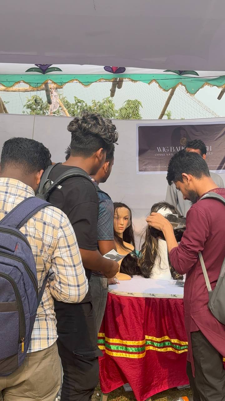 Students examining hair systems at the Wig Bangladesh display