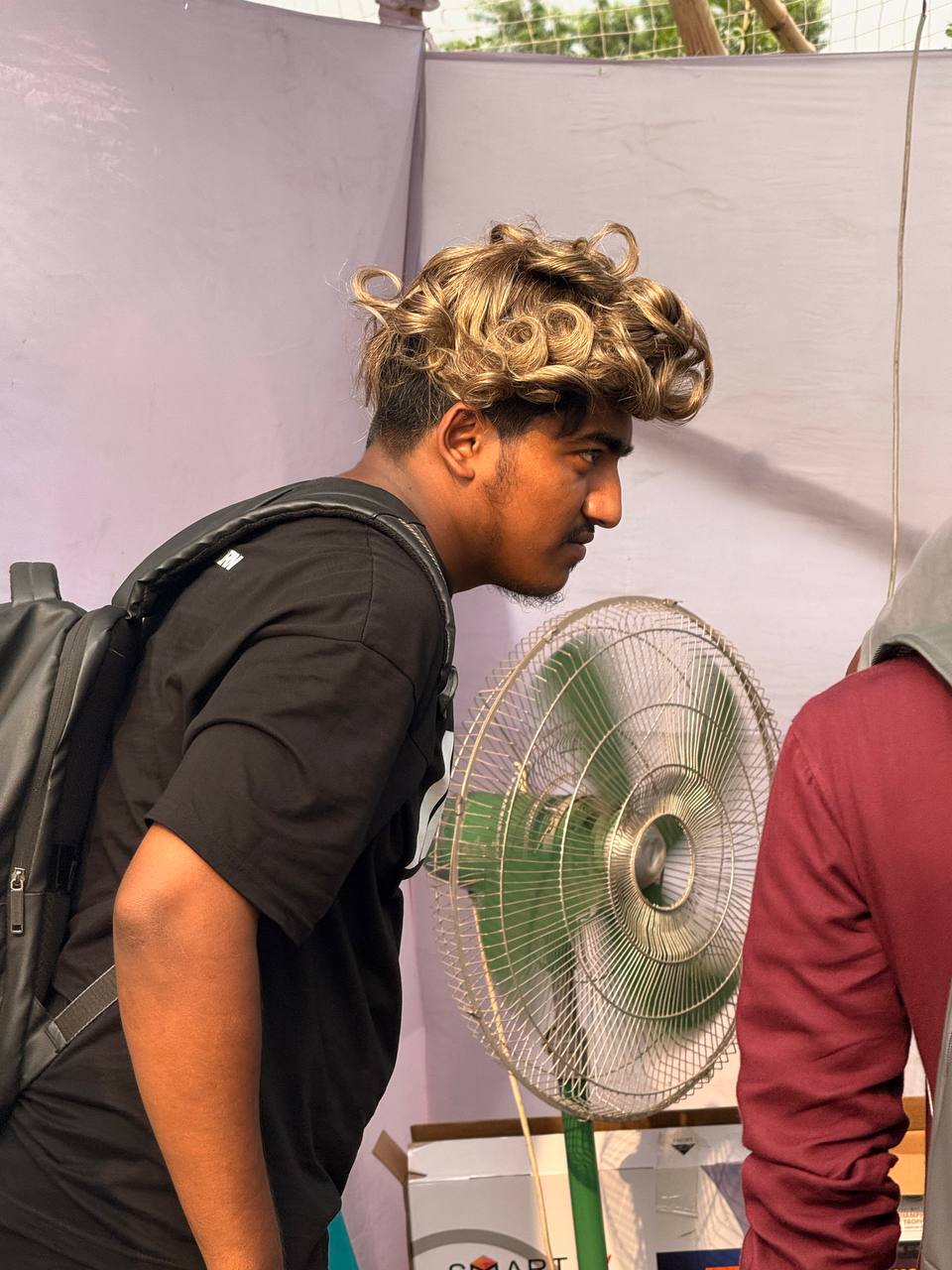 Student trying a highlighted hair system at the cultural function