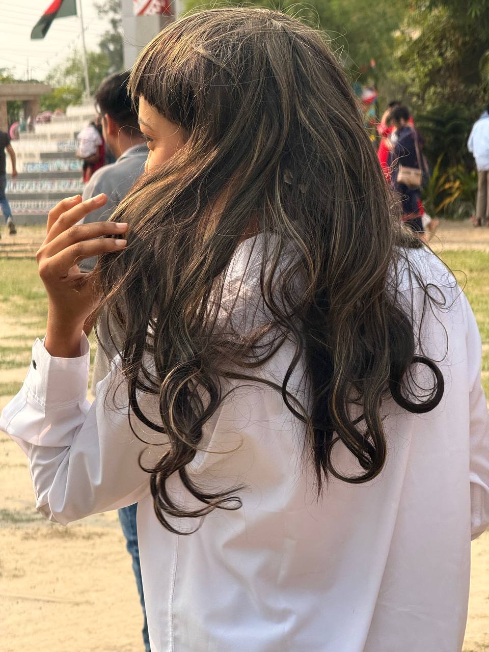 University participant wearing a long layered wig outdoors