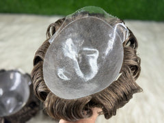 Close-up of a wig with a clear plastic cap on a blurred background