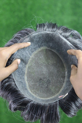 Close-up of a wig hair system showing lace base and hair fibers, demonstrating quality and design for men.
