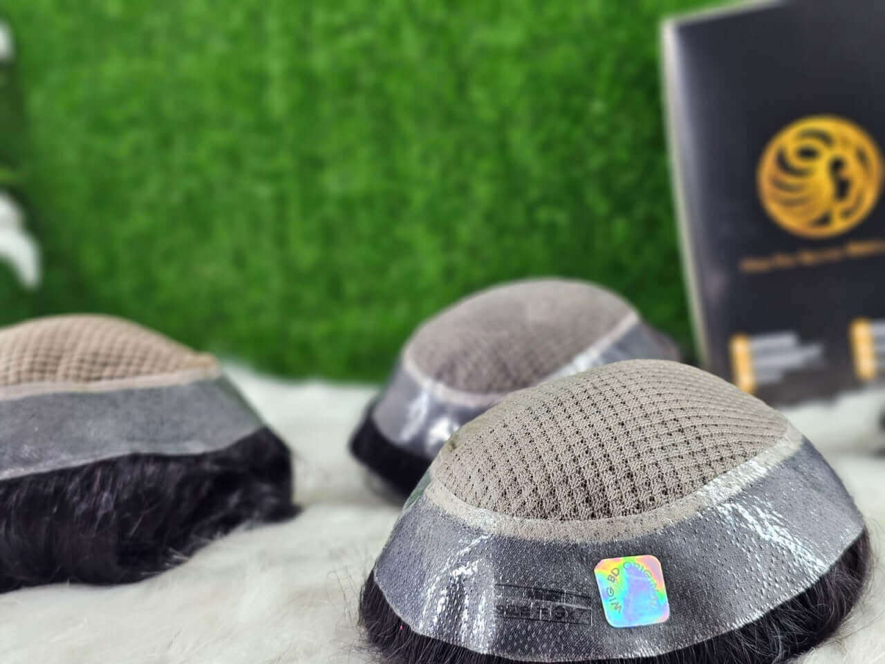 Miraz men's wig displayed on a table, showcasing realistic hair and durable design for men.
