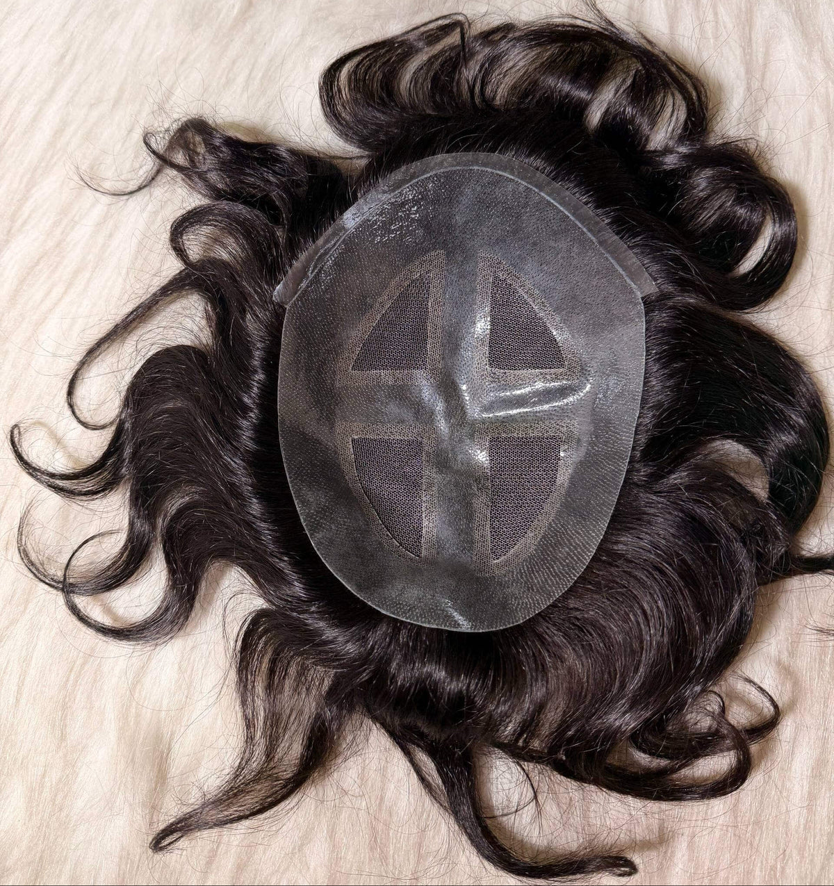 Natural looking men's toupee displayed on a light surface, featuring a secure PU perimeter and premium human hair.