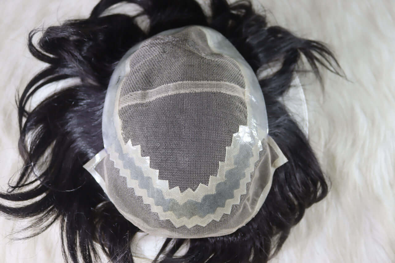 Natural human hair wig for men with a breathable lace cap design on a soft surface.