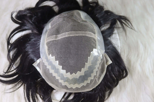 Natural human hair wig for men with a breathable lace cap design on a soft surface.