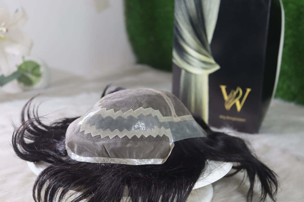 Natural human hair wig for men displayed on a white surface with packaging in the background.