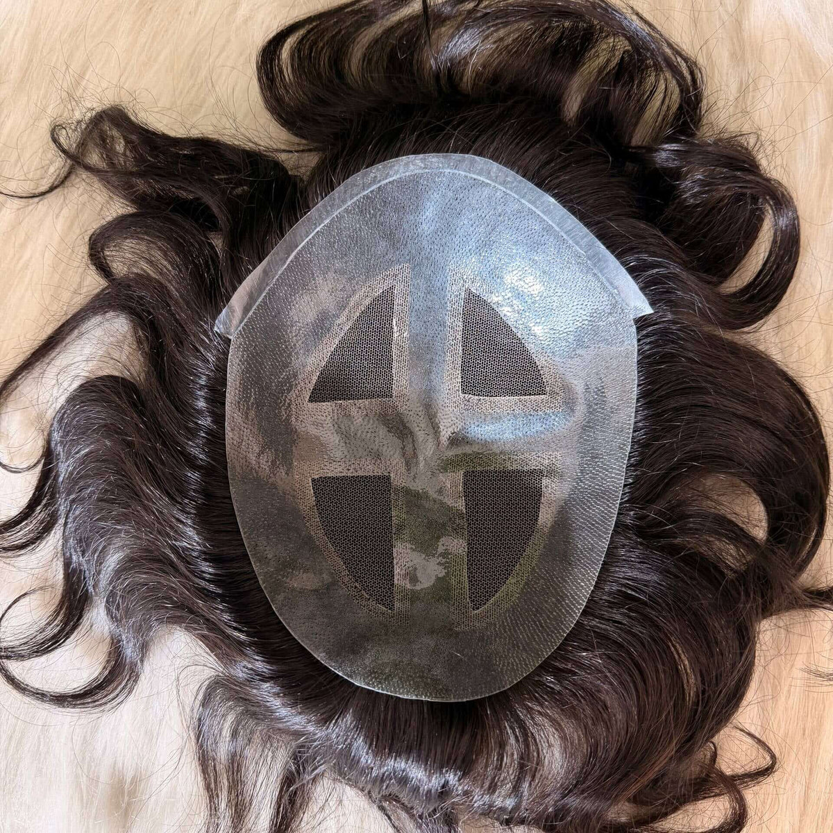 Natural looking men's toupee on a light background, showcasing the premium hair patch system design.
