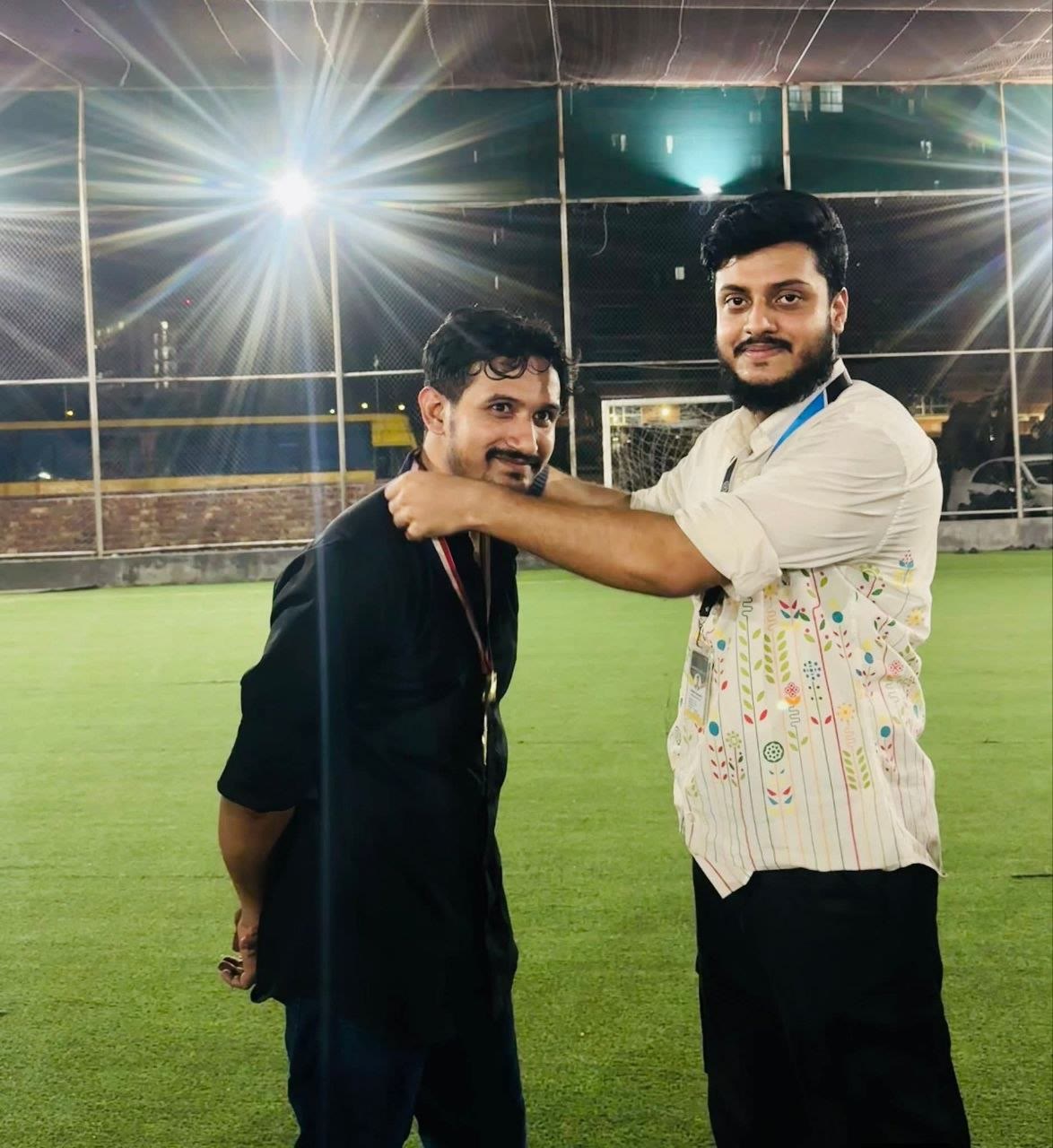 Colleague receiving a football medal
